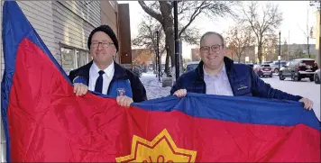  ??  ?? Mayor Denis Perrault and Major Don Grad raise the Salvation Army flag at City Hall.