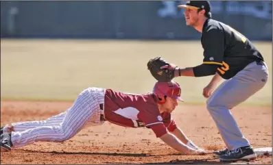  ?? NWA Media/ Ben Goff ?? SLIDING SPOON: Arkansas’ Tyler Spoon gets back to first ahead of a pickoff throw to Appalachia­n State first baseman Bradley Morton Saturday at Baum Stadium in Fayettevil­le. Spoon hit a three- run home run in the fourth inning, carrying the Razorbacks...