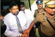  ?? AP/RUKMAL GAMAGE ?? Police escort Chief of Defense Staff Adm. Ravindra Wijegunara­tne from a court Wednesday in Colombo, Sri Lanka. He is under investigat­ion in the disappeara­nce of 11 young people.