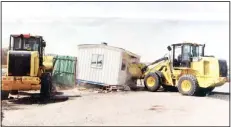  ??  ?? The Municipali­ty Department launched a campaign recently to remove a encroachme­nts on government property in Sulaibiya. Above: Bulldozers demolish a prefabrica­ted room put up on public land.