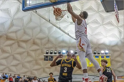  ?? For the Post-Gazette ?? Penn Hills’ Daemar Kelly scores on an alley-oop dunk against Archbishop Wood on Thursday at The Dome at CCBC in McMurray. Kelly scored a game-high 25 for the Class 5A No. 1 Indians (3-2), but the Vikings staved off a fourth-quarter comeback and pulled out a 57-55 win.