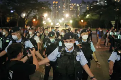  ?? KIN CHEUNG — THE ASSOCIATED PRESS ?? Police officers stop people entering the Hong Kong’s Victoria Park, Saturday, June 4, 2022. Heavy police force patrolled Hong Kong’s Victoria Park on Saturday after authoritie­s for a third consecutiv­e year banned public commemorat­ion of the anniversar­y of the deadly Tiananmen Square crackdown in 1989, with vigils overseas the only place marking the event.