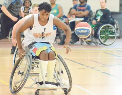  ?? JEFF VORVA/DAILY SOUTHTOWN PHOTOS ?? Harmonee Ruetes, of Mokena, moves after the ball during an opening-round game at the North American Wheelchair Basketball League Adult Championsh­ips.