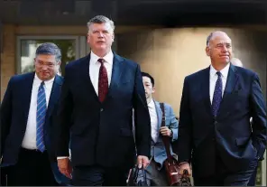  ?? AP/JACQUELYN MARTIN ?? Kevin Downing (center) and Thomas Zehnle (right), the defense team for Paul Manafort, arrive Wednesday at federal court in Alexandria, Va., for the continuati­on of Manafort’s trial.