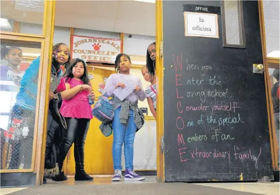  ?? LLOYD FOX/BALTIMORE SUN ?? From left, Kamille Hayes, Makayla Kane, Ada Galdamez Villatora, Sylvia Edozie, Iyonna Cox and Khadija Diop peer into the front office at Johnnycake Elementary.