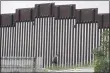  ?? GREGORY BULL — THE ASSOCIATED PRESS ?? On March 18, a Border Patrol agent walks along a border wall separating Tijuana, Mexico, from San Diego, in San Diego.