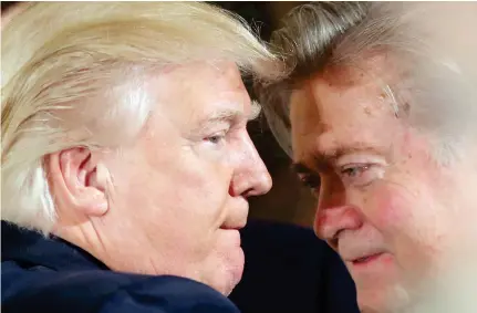  ??  ?? US President Donald Trump talks to chief strategist Steve Bannon during a swearing in ceremony for senior staff at the White House on Jan. 22 in this file photo. (Reuters)