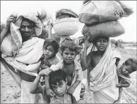  ?? (File Photo/AP) ?? An East Pakistan refugee group seeking safety in India leaves Meherpur, East Pakistan, on April 19, 1971. The group had to seek safety after Bangladesh fighters were forced to retreat by Pakistani government troops.