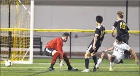  ?? Peter Hvizdak / Hearst Connecticu­t Media ?? Right, Xavier’s Henrique Araujo (in white) scores a goal against Hand on Tuesday night in Madison.