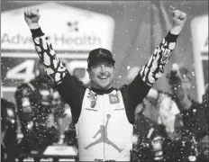  ?? COLIN E. BRALEY/AP ?? KURT BUSCH CELEBRATES in victory lane after winning a Cup Series auto race at Kansas Speedway in Kansas City, Kan., on Sunday.