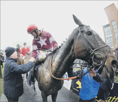  ??  ?? Gordon Elliott, left, congratula­tes jockey JJ Slevin after he had ridden General Principle to victory in yesterday’s Boyle Sports Irish Grand National at Fairyhouse. The 20-1 shot triumphed after a photo and was Elliott’s first winner in the race. See...