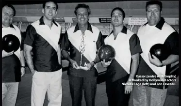  ??  ?? Russo (centre with trophy) is flanked by Hollywood actors Nicolas Cage (left) and Jon Favreau.