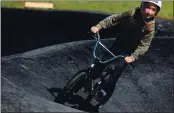  ??  ?? Jaxson Quiroz keeps his concentrat­ion while banking into a turn at the Ramsay Park Pumptrack in Watsonvill­e.