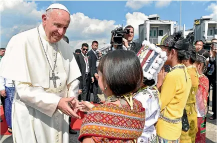  ?? PHOTO: REUTERS ?? Pope Francis is welcomed as he arrives at Yangon Internatio­nal Airport at the start of a three-day visit to Myanmar.