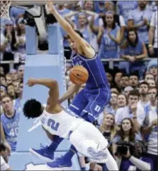  ?? GERRY BROOME — THE ASSOCIATED PRESS ?? North Carolina’s Joel Berry II (2) drives to the basket while Duke’s Grayson Allen, top, defends during the second half in Chapel Hill, N.C., Thursday.