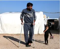  ??  ?? File photo shows a Syrian refugee walks on crutches at a refugee camp in Akkar, northern Lebanon. — Reuters photo