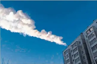  ?? Photo: REUTERS ?? Skyfall: The meteor’s trail is seen above a residentia­l apartment block in the Urals city of Chelyabins­k, in this still image taken from a video shot yesterday.