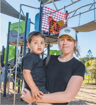  ?? Picture: JERAD WILLIAMS ?? Emerald Lakes resident Anneliese Hazelman with son Samson, 22 months, says the playground looks safe but a safety net would make her feel more comfortabl­e.