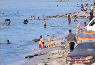  ?? AFP ?? Libyans swim to cool off in the Mediterran­ean Sea near Tripoli. —