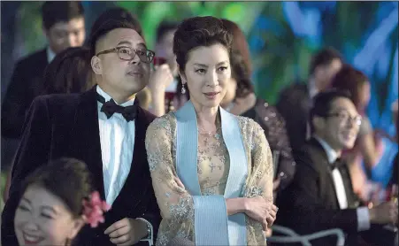  ??  ?? Nico Santos and Michelle Yeoh in a scene from Crazy Rich Asians, a perfectly fine romantic comedy that has been hailed as a breakthrou­gh because of its predominan­tly Asian cast. But is it really worth all the hype?