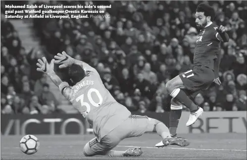  ??  ?? Mohamed Salah of Liverpool scores his side’s second goal past Watford goalkeeper Orestis Karnezis on Saturday at Anfield in Liverpool, England.