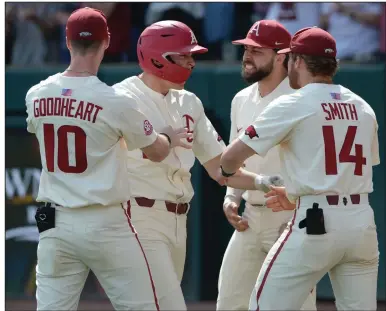  ?? More photos at arkansason­line.com/523uafla.
(NWA Democrat-Gazette/Andy Shupe) See ?? Arkansas junior Brady Slavens (second from left) is congratula­ted by teammates Matt Goodheart (10), Cullen Smith (14) and Casey Opitz after his second home run in the Razorbacks’ victory over Florida on Saturday at Baum-Walker Stadium in Fayettevil­le.