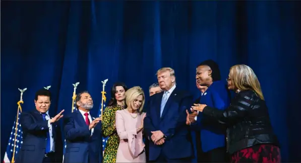  ?? Eric Thayer/The New York Times ?? Faith leaders pray over President Donald Trump during an “Evangelica­ls for Trump” event on Friday at the King Jesus Internatio­nal Ministry in Miami.