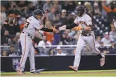  ?? Orlando Ramirez / Associated Press ?? Evan Longoria is greeted by coach Ron Wotus while rounding third base on a home run.