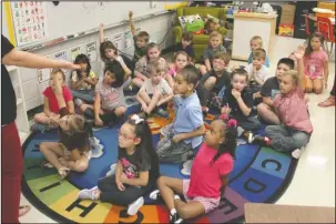  ?? The Sentinel-Record/Richard Rasmussen ?? CLASS IN SESSION: Students in Corrie Roberts’ first-grade class answer questions during the first day of school Monday at Cutter Morning Star Elementary School. Cutter, along with Lake Hamilton, Fountain Lake and Mountain Pine welcomed students back on Monday. Jessievill­e and Hot Springs school districts will return on Wednesday while Lakeside will start classes Aug. 20.