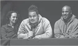  ??  ?? Matthew Pola-Mao (center, with his parents Carrie, left, and Tracey Pola-Mao) announces that he will play football for Kansas State during a signing event at the Chandler Center for the Arts on Wednesday.