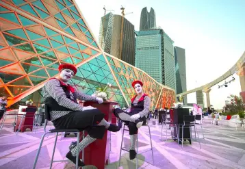  ??  ?? A handout picture provided by the Saudi Royal Palace, shows mime actors sitting outside the AMC cinema in the capital Riyadh ahead of the first test film screening in over three decades. — AFP photo