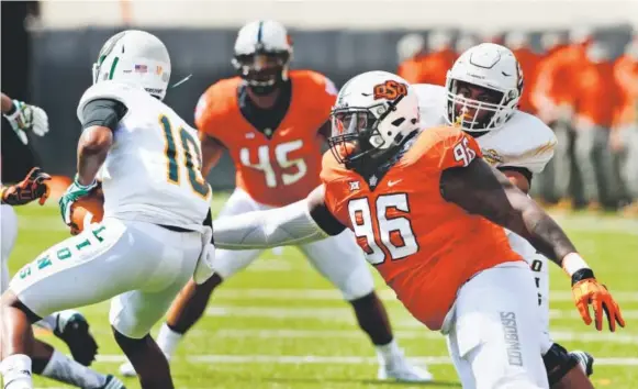  ??  ?? Oklahoma State defensive tackle Vincent Taylor moves in to tackle Southeaste­rn Louisiana quarterbac­k D'Shaie Landor on Sept. 3. Taylor will play in the Alamo Bowl in San Antonio on Thursday, returning home after his family moved to the city from New...