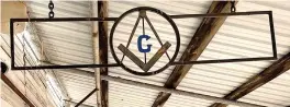  ?? Photos by Neil Abeles ?? ■ The blue and gold Masonic symbol, above, is a compass and square centered with the letter “G.” The letter’s meaning varies. It could be “God” or “Geometry” or stand for the tools of the Great Architect of the Universe.