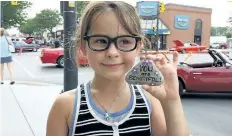  ?? SUPPLIED PHOTO ?? This unidentifi­ed girl shows one of the Port Colborne Rocks rocks discovered by a lamp post in downtown Port Colborne.