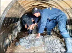  ?? Photo: Patong Municipali­ty ?? Patong Municipali­ty workers clear a partly blocked drain as part of the campaign to clean up the town.