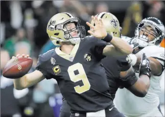  ?? Gerald Herbert The Associated Press ?? Saints quarterbac­k Drew Brees throws an intercepti­on on the first play from scrimmage in Sunday’s NFC divisional-round game in New Orleans. The Saints beat the Philadelph­ia Eagles 20-14.