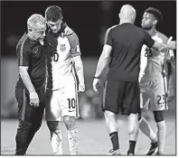  ?? AP/REBECCA BLACKWELL ?? Christian Pulisic (10) of the United States is comforted after losing 2-1 to Trinidad and Tobago on Tuesday and being eliminated from World Cup considerat­ion.
