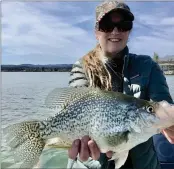  ??  ?? Pictured is my wonderful wife Teresa holding a nice female crappie she caught while bass fishin’ on Clear Lake. The crappie’s stomach was budging with eggs. Rest assured, it was released back so that it could spawn.