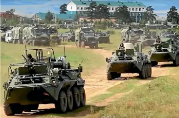  ?? AP ?? Russian armoured personnel carriers roll during the military exercises in the Chita region, Eastern Siberia, during the Vostok 2018 exercises in Russia.