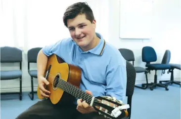  ??  ?? Warragul Regional College student Jye Burton is building on his musical skills following an anonymous donation of a guitar and scholarshi­p from Warragul Community House.