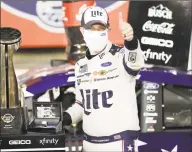  ?? Gerry Broome / Associated Press ?? Brad Keselowski celebrates after winning the Coca-Cola 600 at Charlotte Motor Speedway on Sunday.