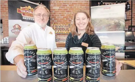  ??  ?? JASON BAIN JASON BAIN Publican House co-founder Marty Laskaris and Canadian Canoe Museum general manager Carolyn Hyslop display cans of Paddler's Ale Tuesday.