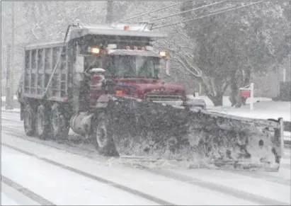  ?? PETE BANNAN – DIGITAL FIRST MEDIA ?? A contract snow plows clears Township Line Road in Upper Darby during Wednesday’s snow emergency.