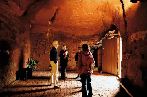  ??  ?? An autumn glow fills ‘the ballroom’ in the central Holy Austin house. Visible on the rock surface are carving marks, striations and recesses which may have supported internal partitions.