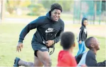  ?? STEPHEN M. DOWELL/ORLANDO SENTINEL ?? UCF football player Anthony Roberson plays with children during a Boys & Girls Club gathering Nov. 21 in Altamonte Springs.