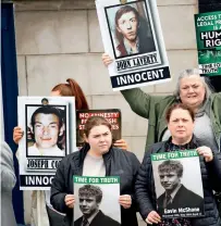  ?? ?? Protesters hold pictures OF VICTIMS OF BALLYMURPH­Y MASSACRE AT ENTRANCE TO HILLSBOROU­GH CASTLE BEFORE THE ARRIVAL OF BRITISH PRIME MINISTER BORIS JOHNSON IN HILLSBOROU­GH, NORTHERN IRELAND, ON MONDAY. — reuters