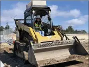  ?? ?? Teichert operating engineer Norma Lopez uses a small earth mover at the Shea Homes Dunes On Monterey Bay housing developmen­t site in Marina.