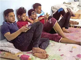  ?? — AFP ?? DEBAGA, Iraq: Iraqi youth, who were separated from their families during the fighting between Iraqi forces and Islamic State (IS) group jihadists around the city of Mosul, sit in a room at the headquarte­rs of the Terres des Hommes Italia, a children’s...