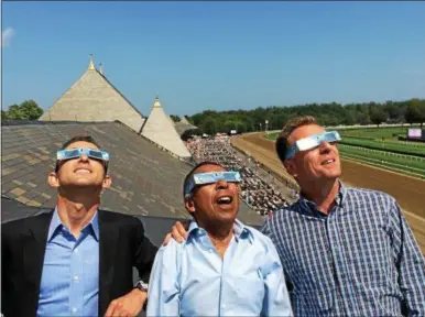  ?? PAUL POST — PPOST@DIGITALFIR­STMEDIA.COM ?? Award-winning jockeys Ramon Dominguez, Angel Cordero and Richard Migliore, left to right, view Monday’s solar eclipse from the clubhouse roof at Saratoga Race Course.