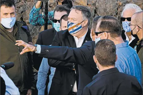  ?? PATRICK SEMANSKY/GETTY-AFP ?? Secretary of State Mike Pompeo is the first top diplomat in U.S. history to visit an Israeli settlement in the West Bank. Above, Pompeo listens Thursday in the Golan Heights.